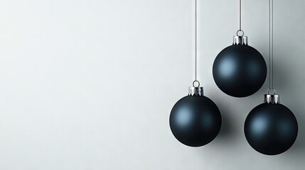 Poster -   Three black Christmas balls dangle from a white string against a white wall in the background, while another white wall stands in the foreground