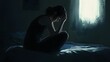 © Berkah - Lonely young woman feeling depressed and stressed sitting head in hands in the dark bedroom, Negative emotion and mental health concept.