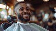 © ifoto - Happy African American man getting a haircut and having his beard trimmed at a barbershop