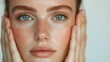 © Intelligent Horizons - Close up portrait of a woman gently framing her face showcasing her clear radiant complexion in a soft bright environment  This tranquil skincare moment exudes a sense of natural beauty wellness