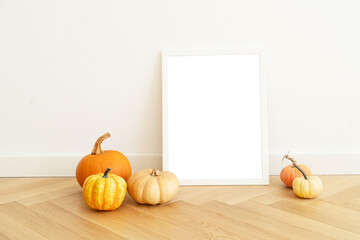 Warm and delightful autumn decor that features charming frames and pumpkins, ideal for creating seasonal styling