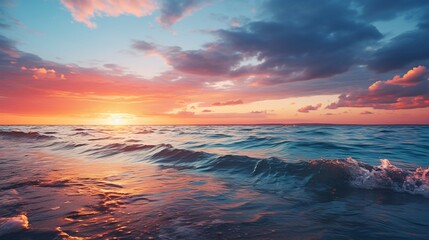 Wall Mural - a stunning view of the sea at sunset with a clear blue sky above