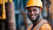 © Liliia - A man wearing a yellow hard hat and orange vest is smiling