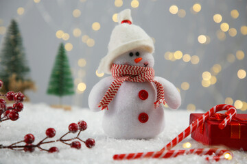 Canvas Print - Cute decorative snowman and other Christmas decor on artificial snow, closeup