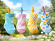 © A-TiMe  - Bright and cheerful socks hanging on a clothesline a splash of color in the great outdoors