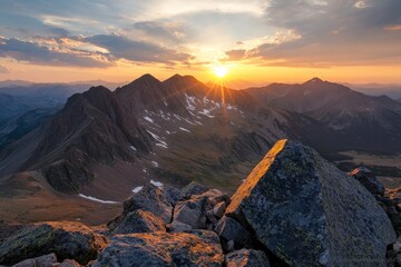 a majestic view of a mountain range during sunset, with the sun casting a golden glow over the rugge