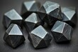© Egor - Close-up of black, faceted, metal dice with a subtle shine.