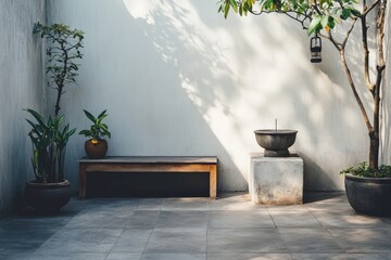 A minimalist courtyard design featuring a wooden bench and potted plants against a plain wall, with ambient lighting creating a peaceful and contemplative atmosphere.