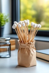 Cotton swabs in natural paper container on a table