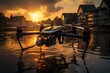© nurionstudio - A drone with a camera is floating on the water with the sunset reflecting on the water behind it.  The drone has red lights on the arms.