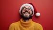 © liliyabatyrova - A man wearing a Santa hat and glasses is smiling and laughing