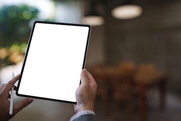 Poster - a businessman holds a mockup. ipad digital tablet with blank screen mockup replaces your design mock