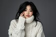 © Zaleman - An attractive woman with clean skin and a fluffy white sweater on a white background