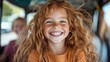 © Maximages  - A young girl with a beaming smile and wild red hair laughs gleefully, capturing the untamed joy and carefree essence of childhood in a vivid scene.