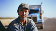 © Bodega - Portrait of male truck driver sitting in cab In the background, softly blur his truck