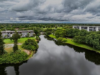 Wall Mural - Aerial view of a suburban landscape with lush greenery under a cloudy sky. Lauderhill, Florida