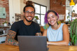 © Pompozzi - Cheerful Young Couple with Laptop in Creative Office