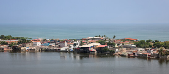 Coastal view of Luanda Angola showcasing waterfront homes along the shoreline under a clear blue sky