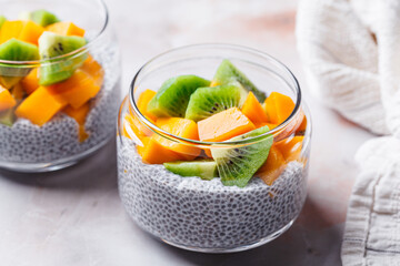 Canvas Print - Chia pudding with mango and kiwi in jar. Vegan breakfast concept.