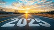 © Kristian - '2025' painted on highway stretching to horizon with sunrise and golden light.