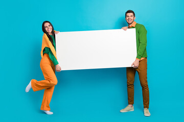 Poster - Full body photo of two workers people courier deliver online shopping order smart gadget isolated on blue color background