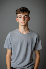 Wall Mural - Teenage boy wearing t-shirt on grey background