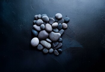 Poster - Smooth gray stones on a dark blue background.