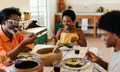 happy brazilian family dining for a traditional meal together at home