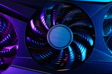 Fototapete - Close-up of high-performance graphics card with cooling fans illuminated by neon lighting. Modern video card for gaming and advanced computing