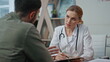 © stockbusters - Medical worker discussing symptoms with patient closeup. Smiling doctor explain