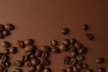 Wall Mural - Many coffee beans on brown background, top view