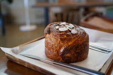 Bread with almond on wooden table in coffee shop