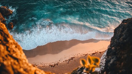 The beach view from the cliffs features a curved shoreline below and gentle waves crashing in, offering stunning views of the sand and sea.