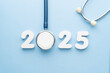 © Orawan - Stethoscope with 2025 number on blue background. Happy New Year for health care and medical banner calendar cover. Creative idea for new trend in medicine treatment and diagnosis concept.