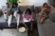 © Caia Image - Group of friends relaxing on sofa