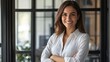 © Johannes - Portrait of young Hispanic professional business woman standing in office. Happy female company executive, smiling businesswoman entrepreneur corporate leader manager looking at camera using tablet