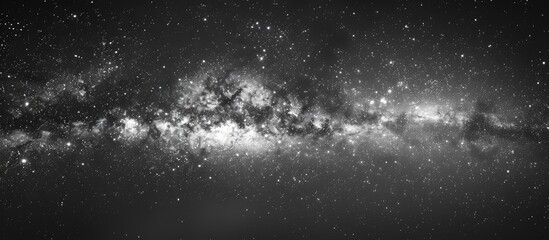 Wall Mural - a striking image showcasing the milky way galaxy against a starry night sky in black and white with 