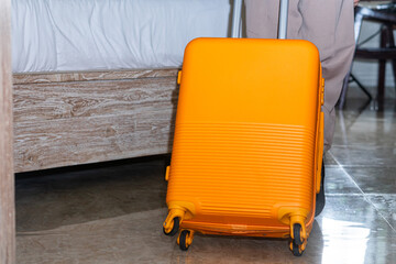 Bright Yellow Suitcase in Hotel Room