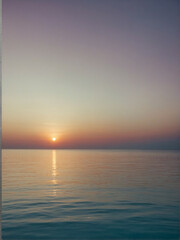 Canvas Print - Tranquil sunset over calm ocean waters reflecting soft pastel colors