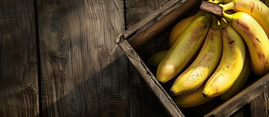 A top down view of ripe bananas displayed in a wooden crate with available space for additional content or text is depicted in the image