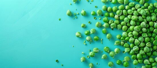 Wall Mural - Green peas displayed on a turquoise backdrop with ample copy space image