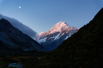 Wall Mural - Mount Cook with moon in blue sky during the dusk at Hooker Valley Track, New Zealand