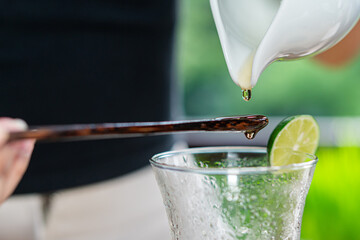 Wall Mural - Refreshing Drink Preparation with Lime and Stirrer