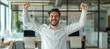 © spyrakot - Joyful Business Professional Celebrating Success in a Modern Office Environment