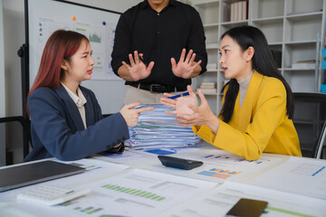 office conflict: two businesswomen engage in a heated disagreement, while a male colleague attempts 