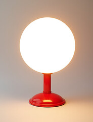 Poster - A simple red and white stand holds a glowing white circular light source for display purposes.