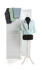 Poster - Female mannequin with stylish shirt and different jeans isolated on folding screen against white background