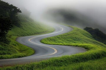 Poster - A scenic road snakes through lush, mist-covered hills, creating a sense of wonder and tranquility amidst a backdrop of vibrant natural greenery and fog.