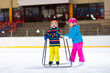 © famveldman - Child skating on indoor ice rink. Kids skate.
