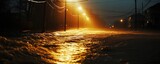 A flooded street illuminated by streetlights, showcasing the effects of heavy rainfall and rising water levels during a stormy night.